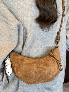 Brown suede croissant shoulder bag with knotted strap and polka dot scarf for women