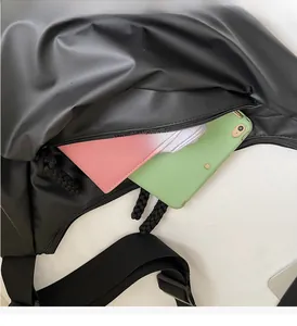 Detail showing internal zipper compartment with spacious storage for phone and wallet