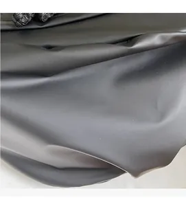 Close-up of soft black synthetic fabric showing elegant folds and matte texture