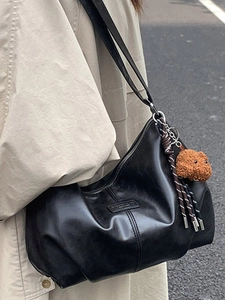 Large black leather hobo shoulder bag for women with a cute brown plush bear charm