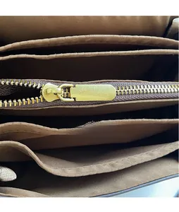 Macro detail of high-quality golden zipper and multi-compartment interior liner