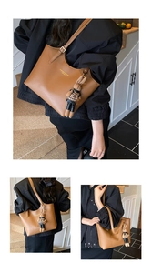 Close-up of brown leather tote bag with gold logo and stylish rabbit charm detail