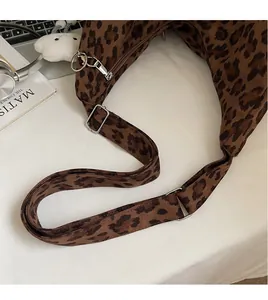 Close-up of adjustable strap and silver metal buckle on leopard print tote bag
