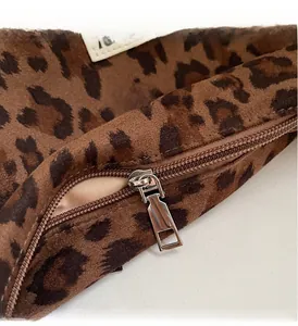 Close-up of the smooth metal zipper and beige lining on this leopard print tote bag