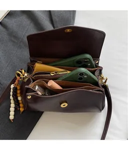 Detail view of multi-compartment interior storage with smartphone and cosmetics