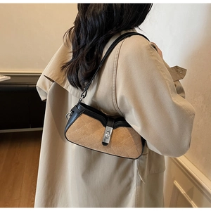 Detail shot of vintage quilted shoulder bag with silver twist lock on khaki trench coat