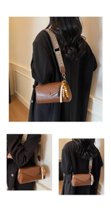 Detail of vintage brown crossbody bag featuring ethnic style woven strap and beaded charms