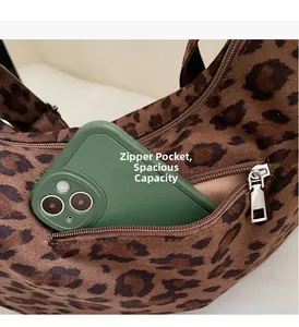 Close-up of leopard print tote bag side zipper pocket showing its large interior capacity