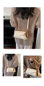 Detail view of cream crossbody bag with vintage colorful beaded strap and gold snap