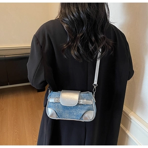 Close-up of blue denim and silver metallic crossbody bag with Y2K buckle detail