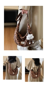 Detail view of leopard print canvas tote bag with plush cloud charm and logo tag