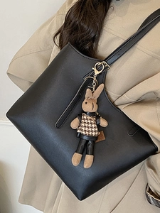 Elegant black leather tote bag with a checkered bunny charm for women's daily commute style