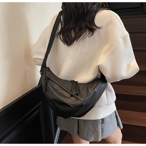 Detailed view of the black moon bag showing waterproof nylon texture and dual zippers