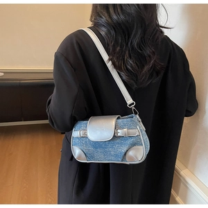 Close-up of blue tweed crossbody bag with silver metallic flap and ZHONGYA logo