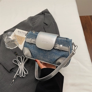 Detail of blue denim and silver leather contrast with adjustable strap and logo embossing