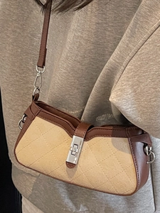 Caramel leather and beige fabric saddle bag with quilted pattern and metal lock