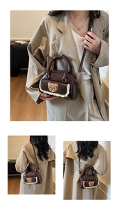 Detail view of a vintage brown handbag with cute plush bear patch and lace trim details