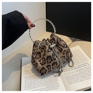 Detail of leopard print bucket bag featuring metal ring handle and chain drawstring