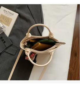 Internal view of the cream tote bag showing storage for phone and cosmetics