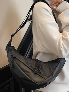 Minimalist black nylon crescent crossbody bag with adjustable strap for casual daily use