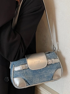 Chic blue denim shoulder bag with silver metallic leather trim and buckle details