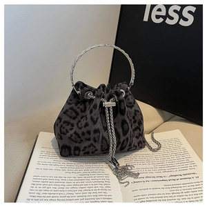 Detail of leopard print bucket bag with silver metal ring handle and chain tassels