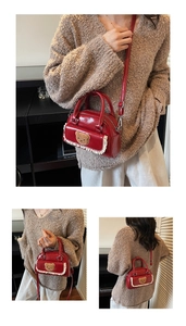 Detail of red glossy handbag with plush bear patch and delicate white lace trim edge