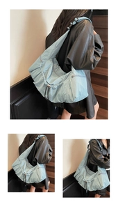 Detail of light blue oversized nylon tote bag with drawstring and wide adjustable strap