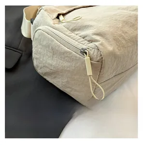 Detailed close-up of ivory nylon tote bag with natural texture and sleek metal zipper