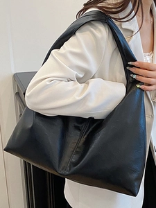 Minimalist black leather hobo bag with wide shoulder strap and large capacity design