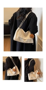 Detail of cream faux leather tote featuring a chain strap and a cute teddy bear charm