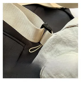 Detail shot of lightweight nylon tote bag with wide strap and matte black hardware