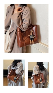 Dettaglio della grande borsa tote marrone vintage con ciondolo a forma di coniglio e tracolla