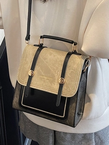 Vintage-style two-tone crossbody bag with top handle and gold logo in 2025 autumn fashion