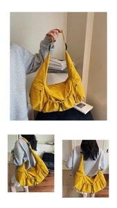 Detail view of yellow nylon tote bag showing drawstring closure and crossbody strap texture