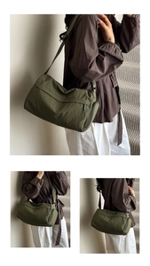 Detail view of army green nylon tote bag with adjustable strap and side zipper pockets