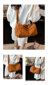 Detail of tan nylon cylinder crossbody bag with orange zip pulls and side pockets