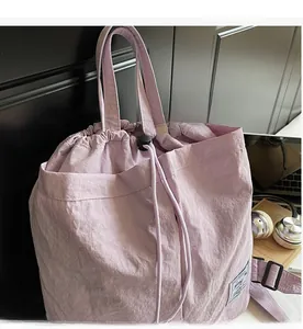 Close-up of lilac drawstring backpack with durable cord and adjustable black buckle detail