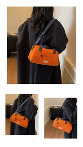 Close-up of bright orange nylon pillow bag featuring front zipper and JL FASHION label