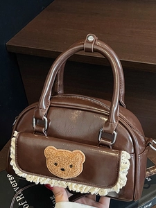 Minimalist dark brown leather shoulder bag with plush bear patch and lace details