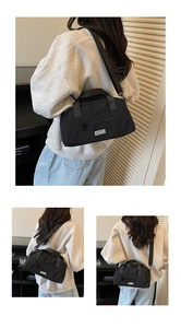 Detail shot of black nylon pillow bag featuring metal zipper and JL FASHION brand label