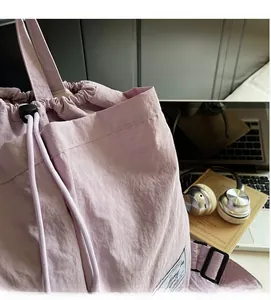Detail of light purple drawstring backpack with premium textured nylon and adjustable cords