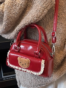 Minimalist red leather bowling bag with teddy bear patch and lace detail for women