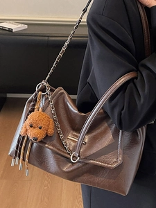 Retro dark brown large tote bag with shiny oil leather finish and plush puppy charm