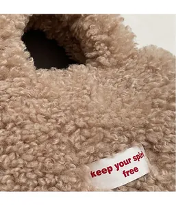 Detailed macro view of soft brown teddy fleece material and fabric spirit free woven label