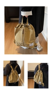 Detail of khaki water-resistant nylon backpack showing drawstring closure and brand label
