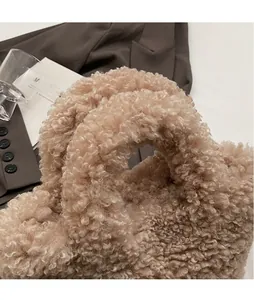 Close-up of the beige teddy fleece handbag handle showing soft curly plush texture