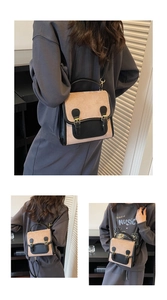 Detail view of the vintage two-tone mini square bag with dual metal buckles and strap