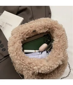 Top view showing the spacious interior of the beige plush lambskin bucket bag with metal chain