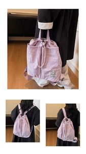 Detailed view of lavender drawstring backpack with durable nylon fabric and woven label